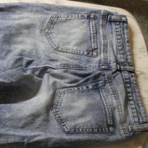 Ripped unworn blue jeans